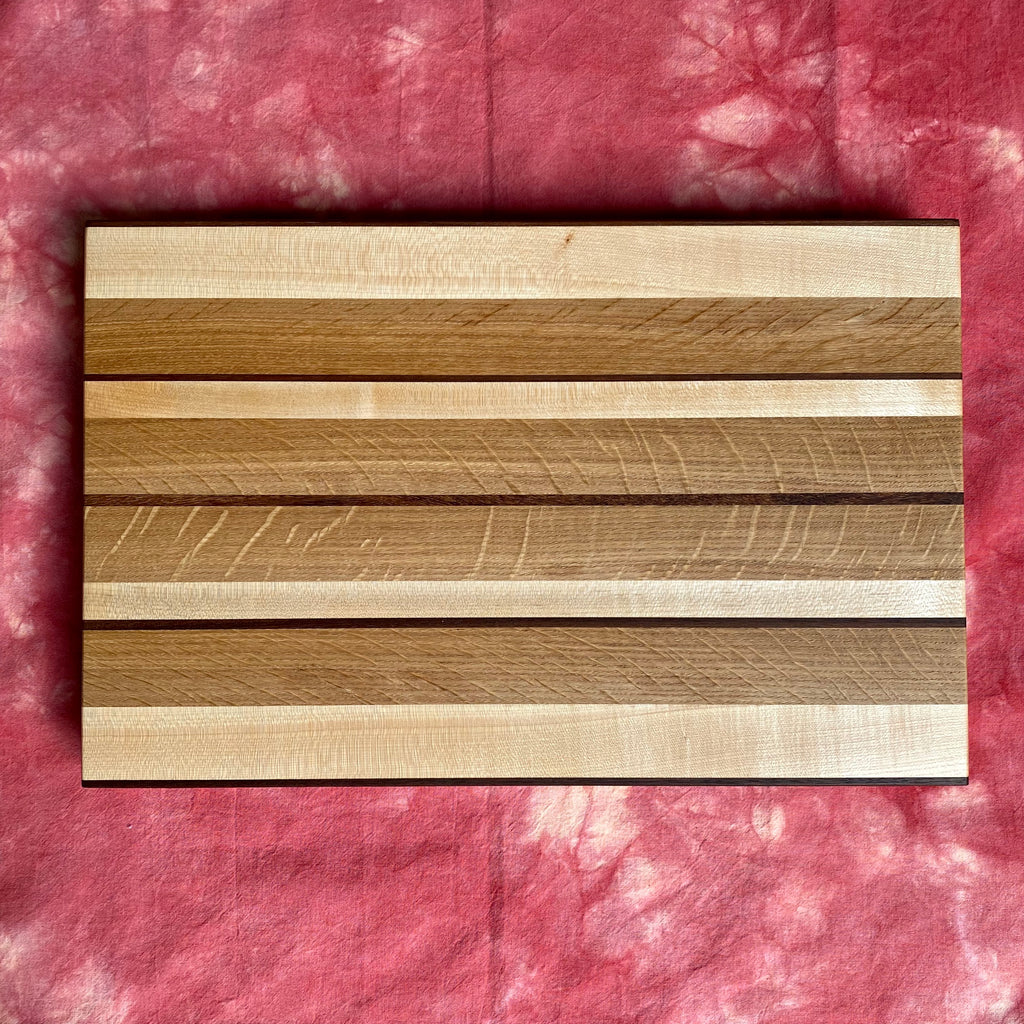 striped bookmatched white oak black walnut and maple striped hardwood cutting board